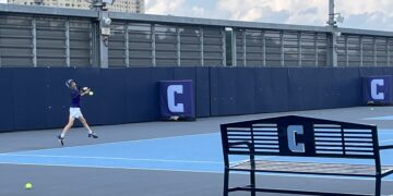 An inspired young camper displaying fine form at the Columbia Summer Tennis Camp