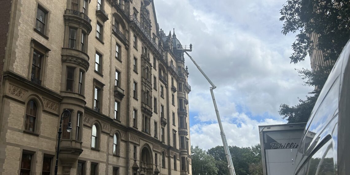 Man in the Clouds Works on The Dakota Building: See It