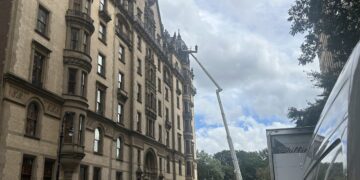 Man in the Clouds Works on The Dakota Building: See It