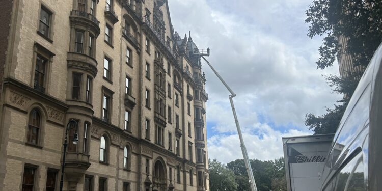 Man in the Clouds Works on The Dakota Building: See It